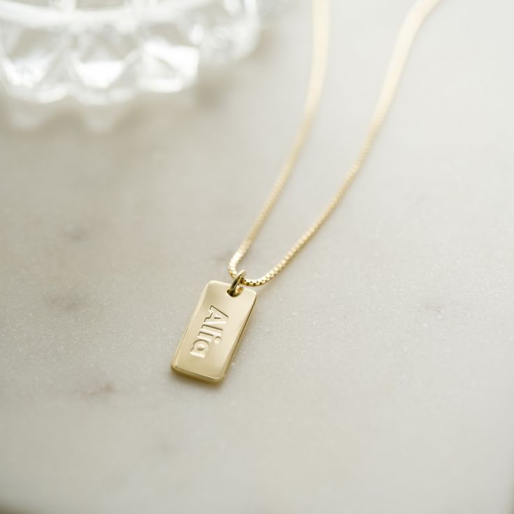 Personalized name & date necklace made just for you! Perfect for remembering key dates like weddings & anniversaries, graduations, and so much more! - - - D E T A I L S- - -• Made of 925 Sterling Silver• Available in 14k Gold, or Rhodium plated (we use a very THICK plating for a piece that will be with you for years to come!)• Nickel-free & Hypoallergenic• DIMENSION: 16mm x 8mm •Comes with a 3" Extension Chain ♡ HOW to ORDER: ♡1. Use the "PERSONALIZATION BOX" to input the DATE/NAME/LETTERS /SYMB Dainty Hand Stamped Necklaces For Anniversary, Charm Necklaces With Rectangular Pendant For Anniversary, Father's Day Anniversary Dog Tag Necklace, Everyday Personalized Rectangular Pendant Necklace, Classic Pendant Charm Necklace For Mother's Day, Classic Pendant Jewelry For Anniversary Gift, Classic Rectangular Pendant Jewelry For Anniversary, Elegant Dog Tag Jewelry As Gift, Elegant Dog Tag Jewelry Gift