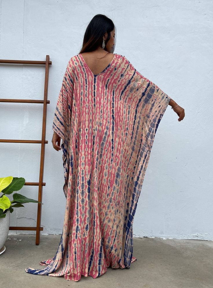 Dive into a world of vibrant color and unique patterns with our tie dye kaftan. Each piece is a masterpiece of individual hand tie-dyeing, ensuring that no two are alike. Crafted with meticulous care and attention, these kaftans offer a burst of style and creativity. Whether you're lounging at home, heading to the beach, or stepping out for an evening on the town, our tie dye kaftan is the perfect choice to make a bold and unforgettable fashion statement. Embrace the artistry and individuality o Latest Kaftan Designs, Maxi Wedding Guest Dress, Pink And Blue Tie Dye, Pregnancy Gown, Blue Caftan, Plus Size Caftan, Maxi Maternity Dress, Tie Dye Kaftan, Kaftan Designs