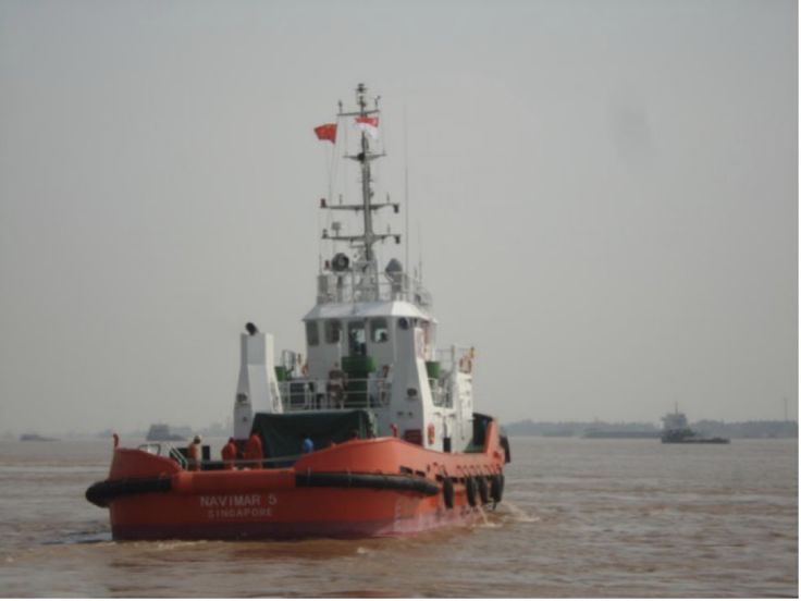 a large boat floating on top of a river next to another boat in the water