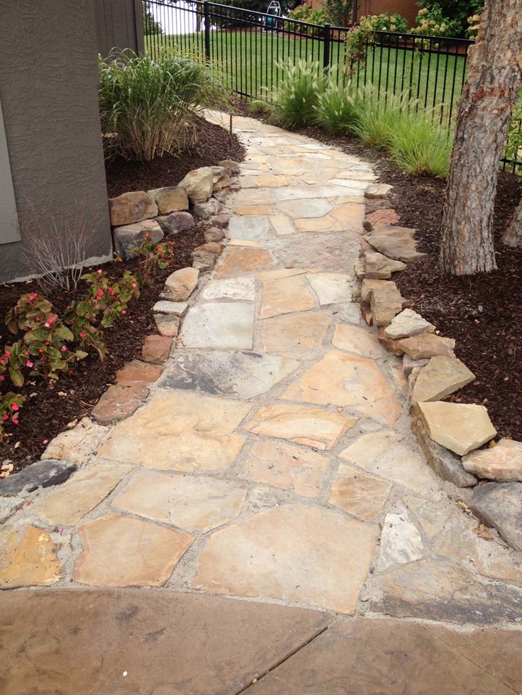 a stone path in front of a house