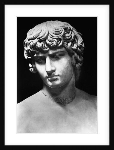 a black and white photo of a bust of a man with curly hair, wearing a necklace