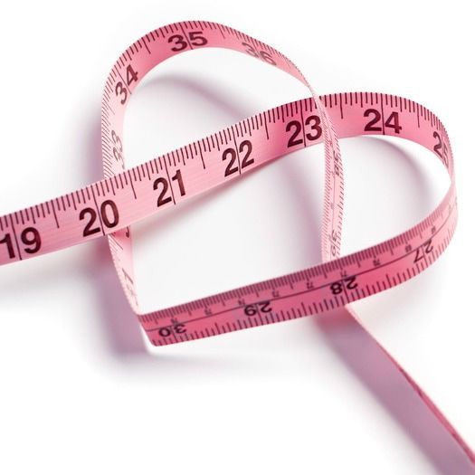 a pair of pink measuring tape on white background