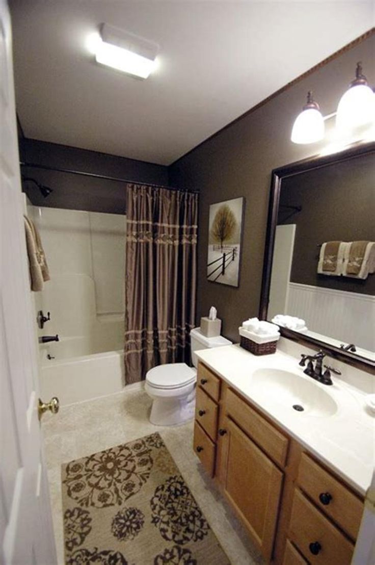 a bathroom with a sink, toilet and bathtub is seen in this image from the doorway