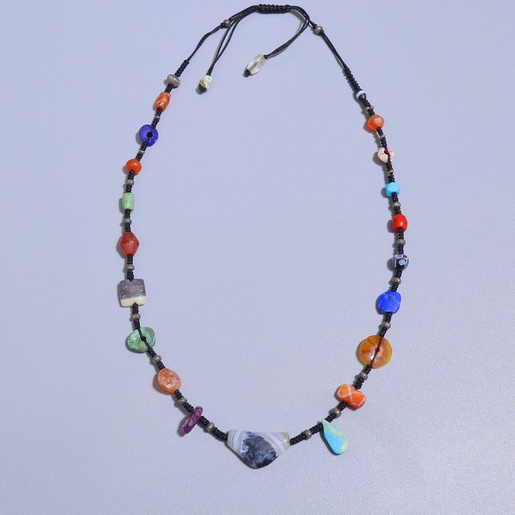 A beautiful hand crafted necklace made with ancient Lapis, turquoise, etched carnelian, sulemani agate, coral. the coral is from yemen circa 1400AD all other beads are Afghan origin circa 100AD-200BC. the necklace is made with very fine thread which feels comfy around the neck & gives a very pleasant vibe. All the beads are 100% real antiques found in excavations at different sites. they are not manufactured now or modified but were created by ancient humans by hand. literally one of a kind necklace!! Spiritual Amber Jewelry With Colorful Beads, Bohemian Hand-strung Lapis Lazuli Jewelry, Traditional Necklaces With Natural Stones For Meditation, Healing Amulet Jewelry With Natural Stones, Agate Amulet For Healing, Handmade Multicolor Turquoise Amulet Necklace, Bohemian Carnelian Necklaces For Meditation, Carnelian Amulet Jewelry With Round Beads, Unique Carnelian Jewelry With Colorful Beads