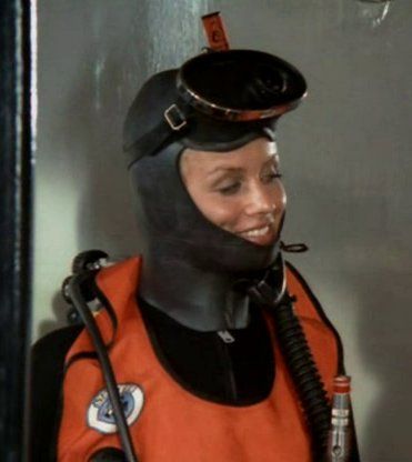 a woman in an orange space suit holding a bottle