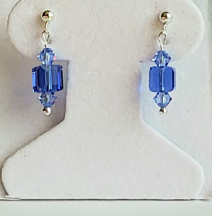 "- Sapphire Blue Cube Crystal Stud or Post Earrings in Swarovski Faceted 6mm Cube in gorgeous Sapphire Blue shade. See Photos #1-3. - Swarovski Faceted Crystal 4mm Bicones in Light Sapphire on each end. - Drop Length 7/8\". - 925 Sterling Silver Posts/Studs with 3mm Ball Ends. 925 Sterling Silver Push Backs included. - See 925 Sterling Silver Bali Hook with Ball Ends version separately Listed. See Photo #4-5. - Leverbacks or Angular Hook Ear Wires upon request at no cost. Give us a Note on Etsy Cube Earrings, Diy Earrings Easy, Petite Earrings, Beaded Earrings Diy, Jewelry Making Earrings, Cube Beads, Light Sapphire, Earring Collection, Earrings Inspiration