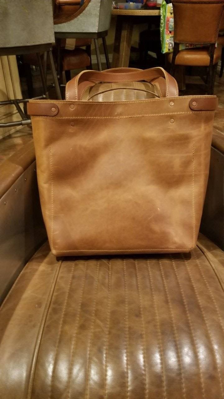 "The Jernigan is a large leather everywhere tote . It measures 14\" x 16\". It has mutliple interior and exterior leather pockets. Great as business tote or a stylish go everywhere bag. Please let us customize one to fit your needs and style. All items are made to order so please allow 2 to 3 weeks for creation and delivery." Tan Bags With Leather Lining For Everyday Use, Leather Backed Tote Shoulder Bag For Travel, Leather Tote Briefcase With Large Capacity, Tan Leather Lining Bag For Everyday Use, Shopping Tote Briefcase With Large Capacity, Large Capacity Tote Briefcase For Shopping, Everyday Tan Satchel, Classic Large Satchel For Everyday Use, Large Satchel With Leather Handles For Everyday