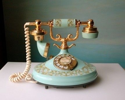 an old fashioned phone sitting on top of a table