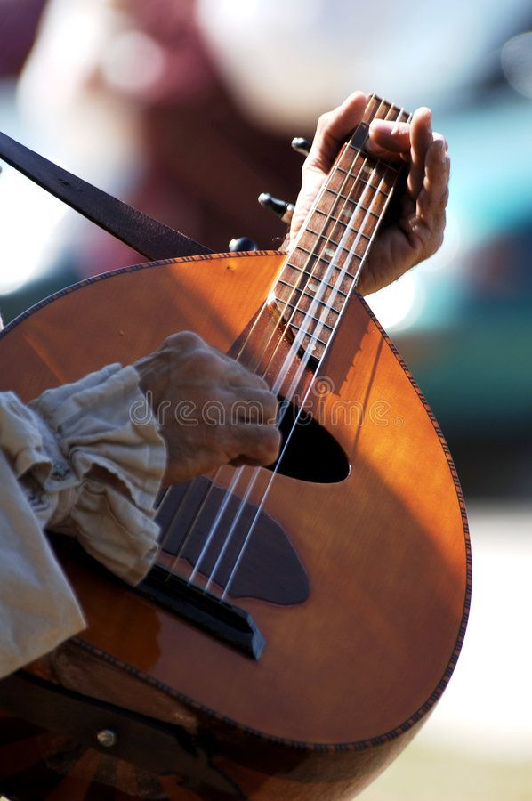 a close up of a person holding a ukulele in their hands royalty images