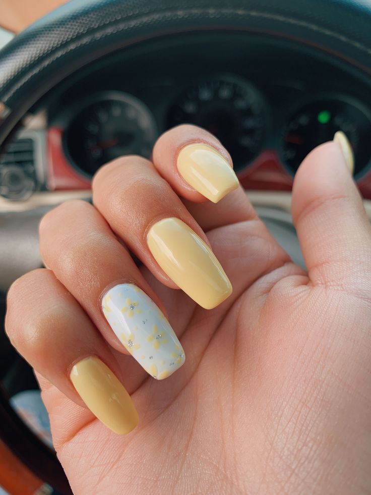 Pastel yellow nails with one white finger with yellow daisies and some silver on it as well#Yellow #design #white #nail #andYellow and white nail design Yellow White Nails Design, White Nails With Yellow Design, Pastel Yellow Gel Nails, Manicure Amarillo Pastel, Summer Nails Yellow Pastel, Yellow And White Nails Design, White Yellow Nails, Pastel Yellow Nails Design, Yellow White Nails