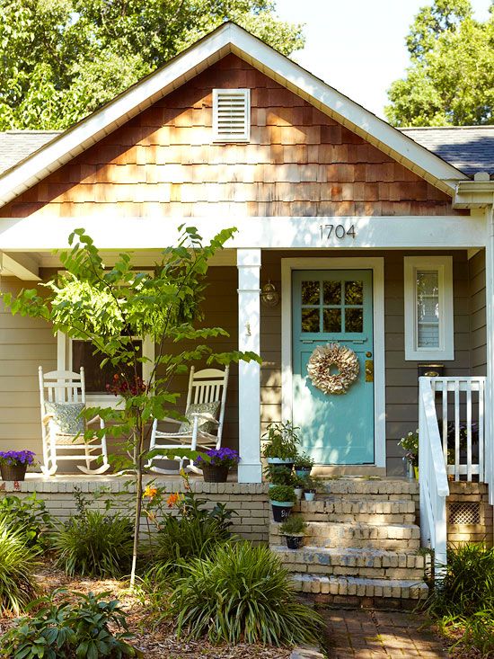 a small house with a blue front door and white shutters on the windows is featured in pinterest