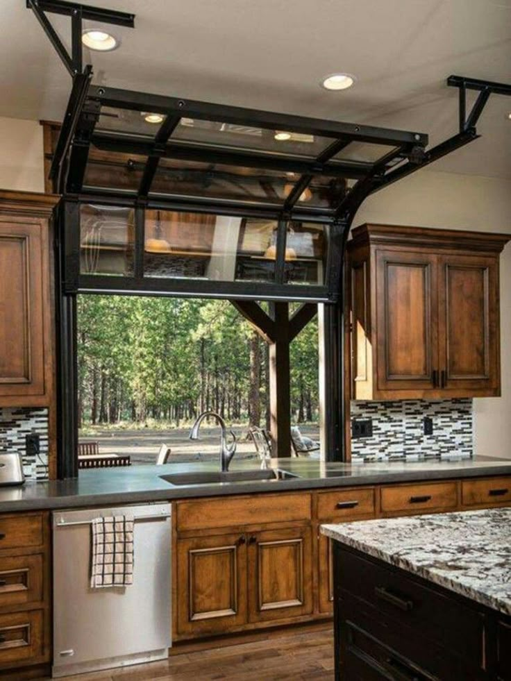 an open kitchen with wooden cabinets and stainless steel appliance on the left side