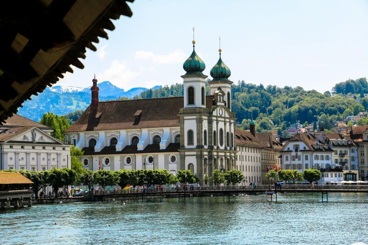 an old church on the side of a river