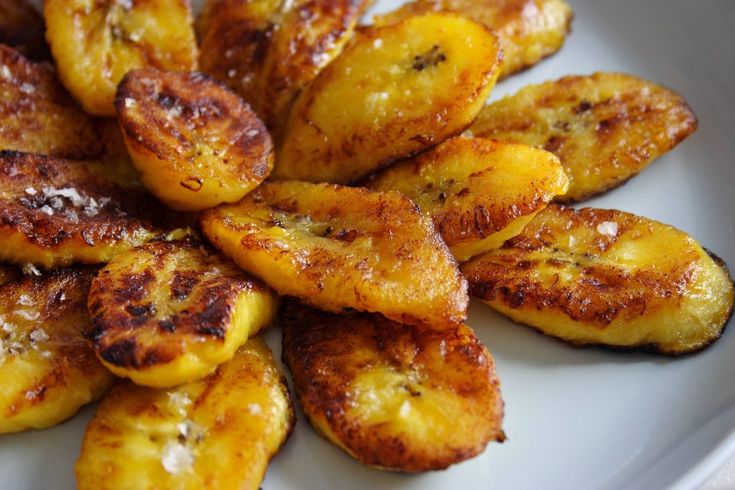 a white plate topped with sliced bananas on top of a table