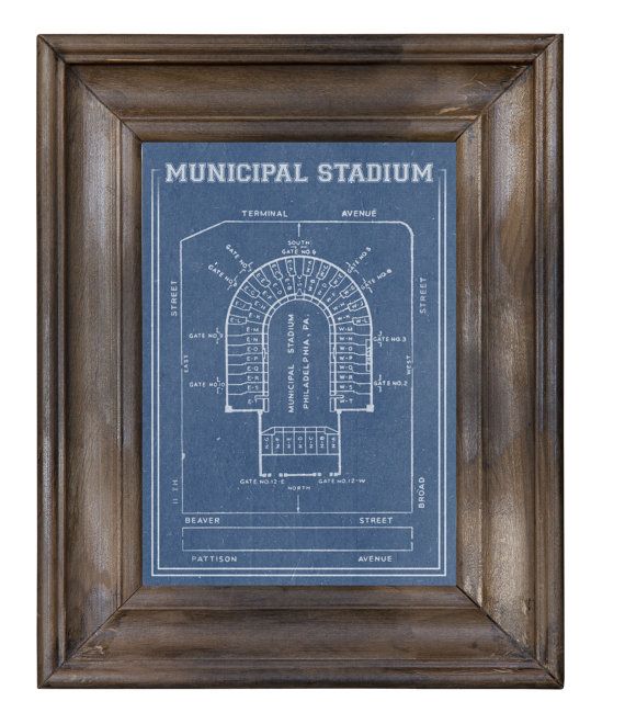 a framed blueprint with the words municipal stadium in white lettering on it, and an old wooden frame