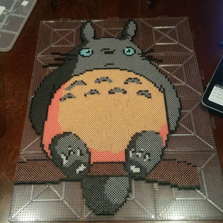 the rug is made out of legos and has an image of totoro on it