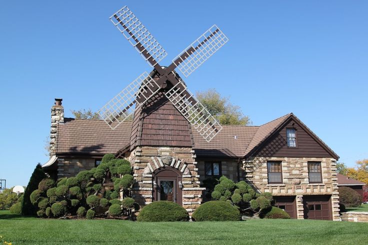 a house with a windmill in the front yard