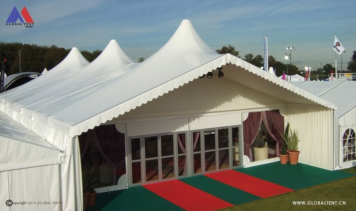 a large white tent with red and green carpet