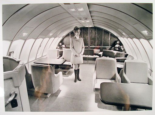 a man standing in the middle of an airplane cabin