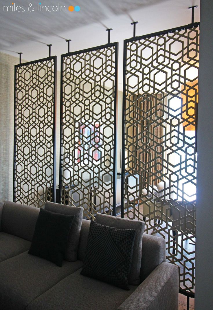 the living room is decorated with black and white decor, including an intricate screen divider