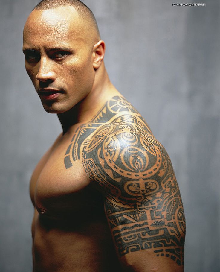 a man with tattoos on his arm and chest