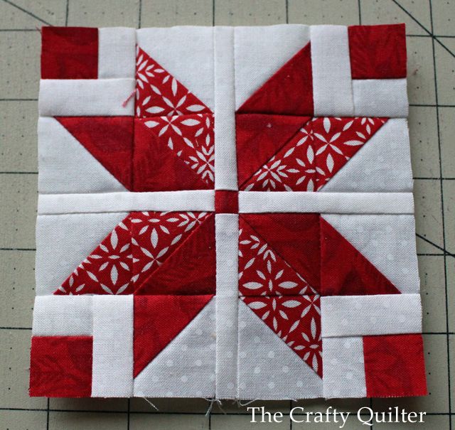 a red and white quilted block sitting on top of a table