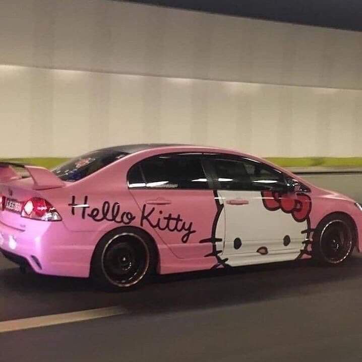 a pink car with hello kitty painted on it