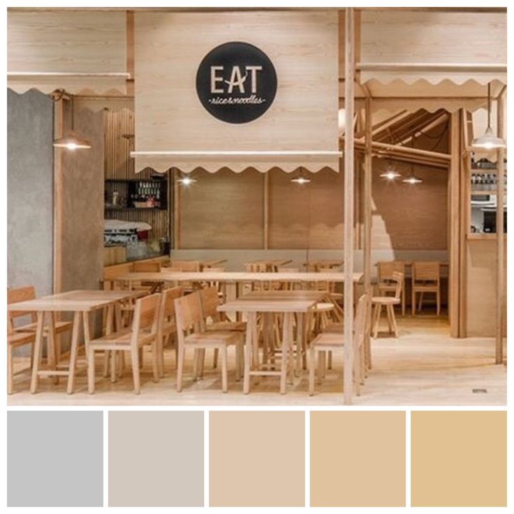 the inside of a restaurant with wooden tables and chairs, an eat sign on the wall