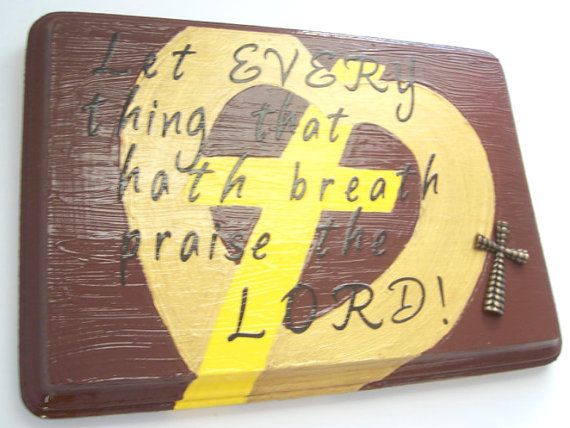 a wooden plaque with a cross on it that says, let every thing eat half the bread and praise him lord