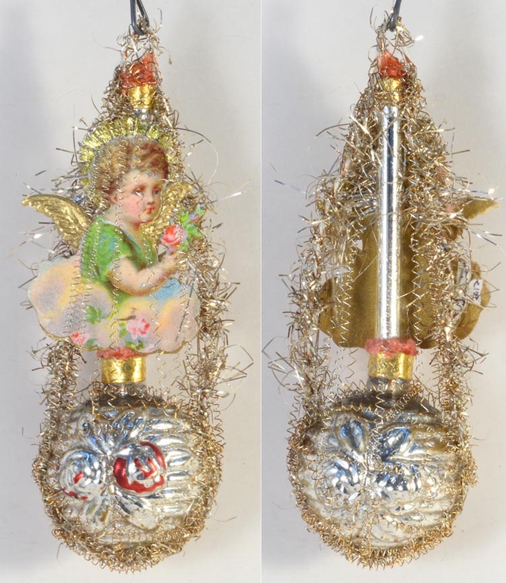 two christmas ornaments with tinsel and angel decorations on the top one is hanging from a wire