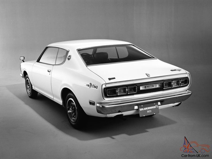 an old white car is parked in a black and white photo