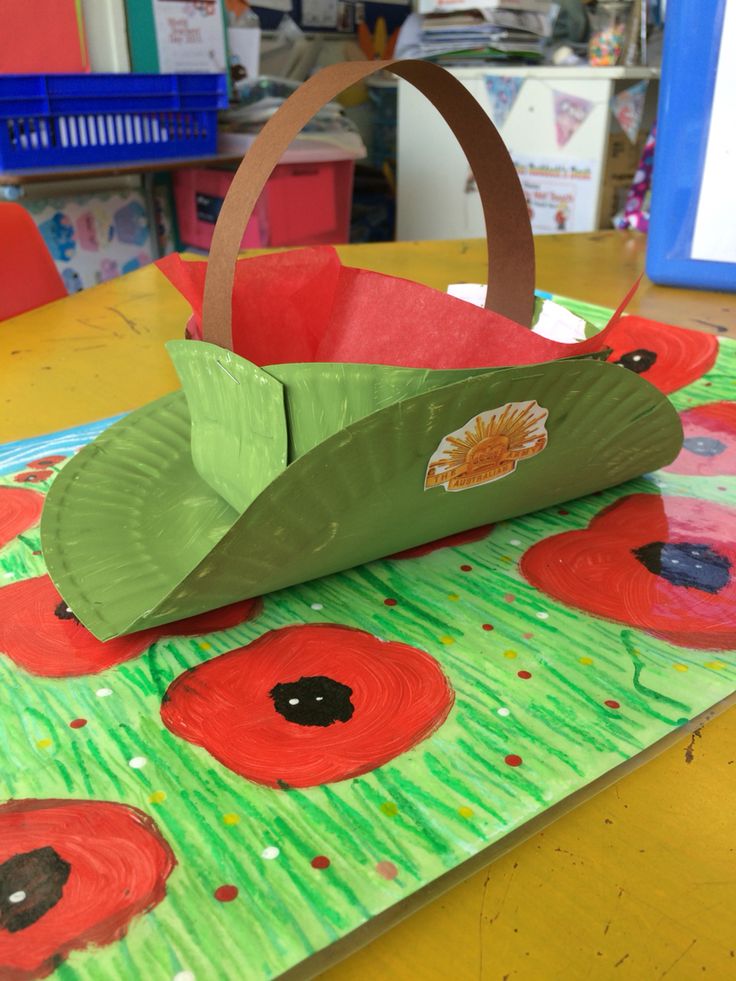 a paper bag made to look like an origami boat with poppies on it