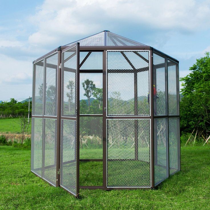 a large metal cage in the middle of a field