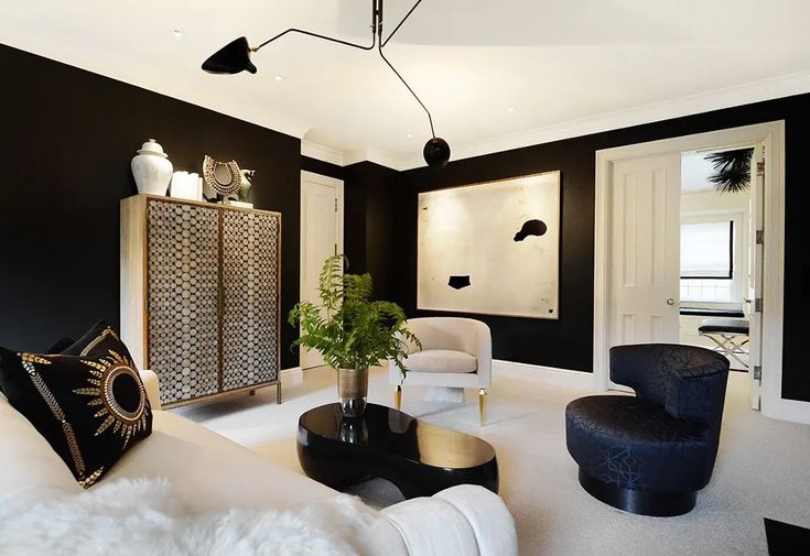 a living room with black walls and white furniture