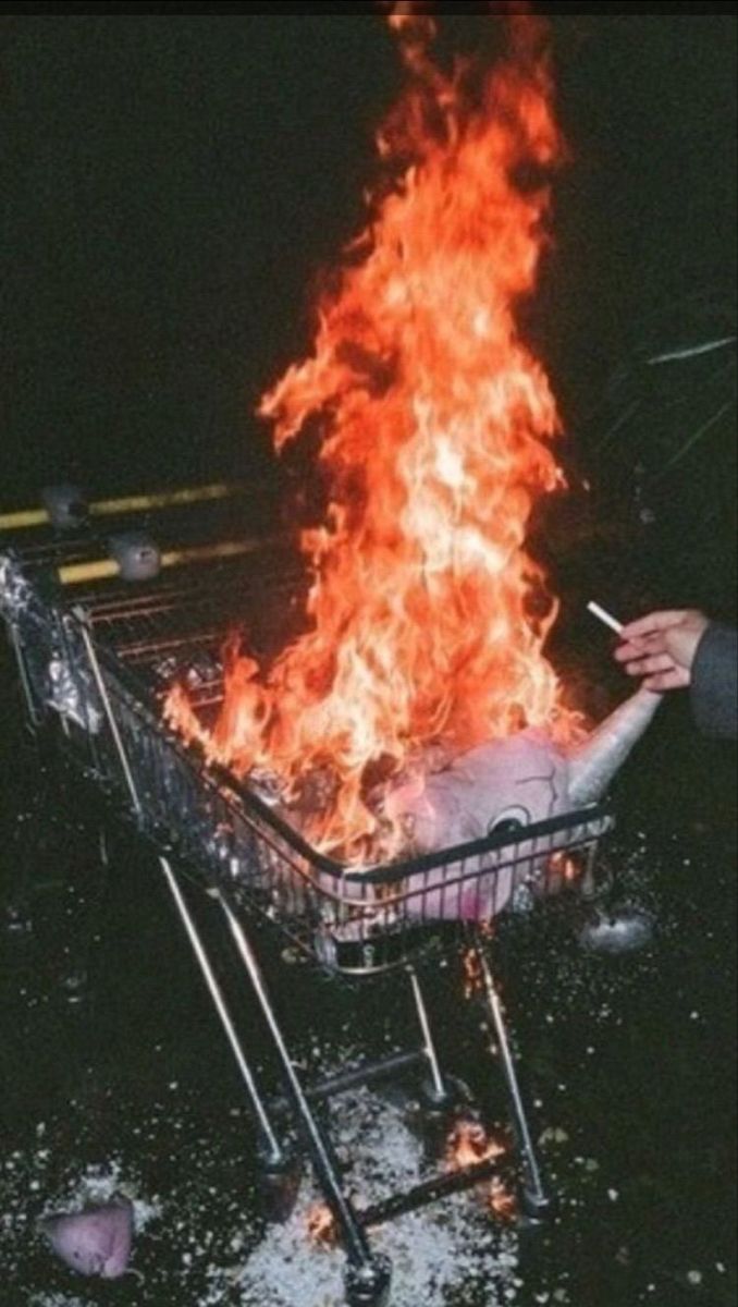 a shopping cart on fire in the dark