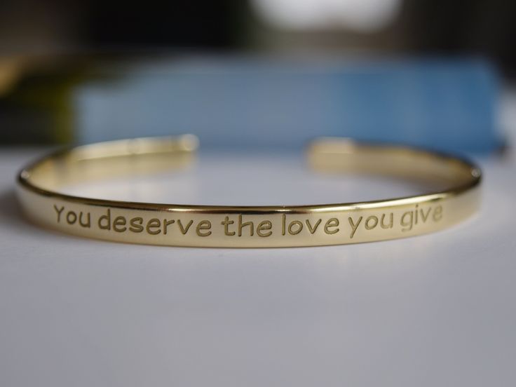 "Our Gold plated bracelets are coated with 22K gold and the thickness of the gold layer is 0.5 microns. It's sufficient even for jewellery pieces that are exposed to rough wear. There is no way that the colour will wash off or tarnish. - Narrow bracelet engraved with your chosen message. - The thickness of gold plating is around 0.5 microns - Text, coordinates, numbers or handwriting outside and inside the cuff - The bracelet doesn't tarnish, the color doesn't wear off - Up to 90 characters on e Meaningful Engraved Name Bracelet, Inspirational Engraved Name Bracelet, Gold Engraved Name Bracelet With Meaningful Style, Inspirational Gold Name Bracelet For Personalized Gift, Gold Name Bracelet For Friendship, Gold Friendship Bracelet With Meaningful Style, Gold Engraved Inspirational Name Bracelet, Inspirational Engraved Bangle Bracelets, Inspirational Gold Engraved Name Bracelet