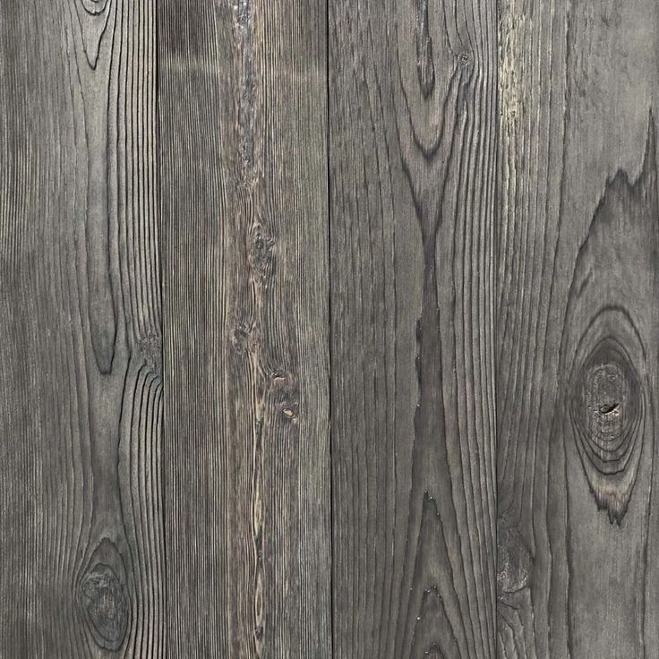 an image of wood planks textured with grey paint on the walls and floor