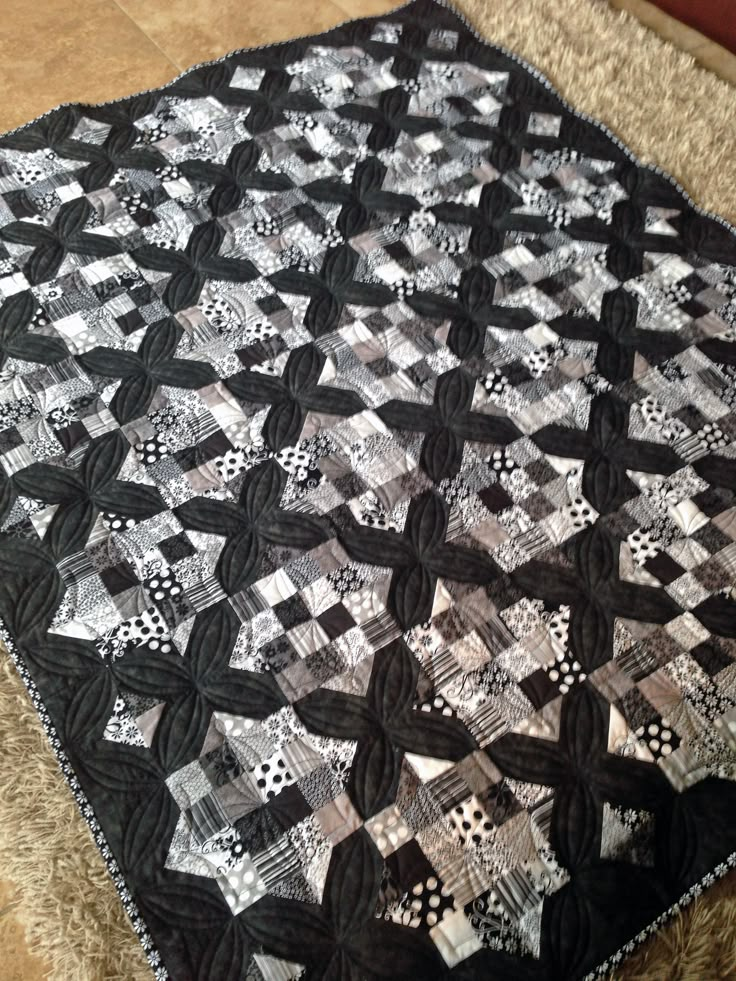 a black and white quilt sitting on top of a couch