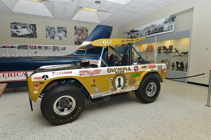 a yellow and white truck parked inside of a museum