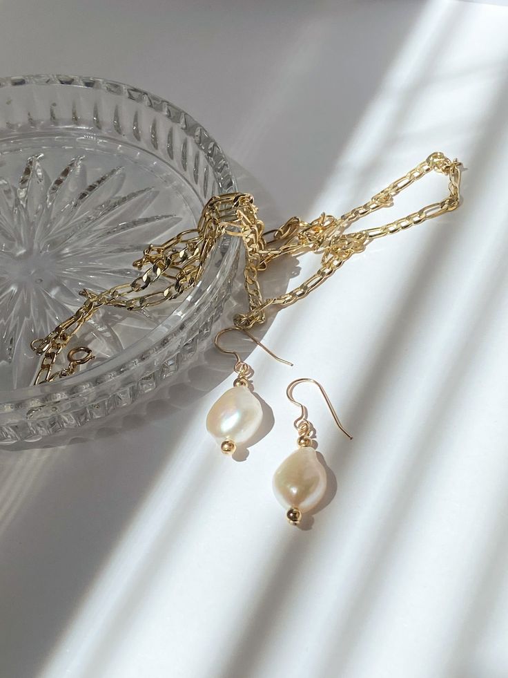 A beautiful and unique baroque pearl paired with two gold beads to create a stunning and classic piece. They are made with cultured pearls and gold filled materials. They are safe to wear in water, but should stay away from chemicals like soaps, lotions, and perfumes. Shoe Charms, Baroque Pearls, In Water, Cultured Pearls, Gold Beads, Shop Necklaces, Chemicals, Necklaces Bracelets, Gold Filled