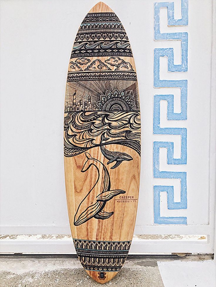 a wooden surfboard with an image of a dolphin on it's back end