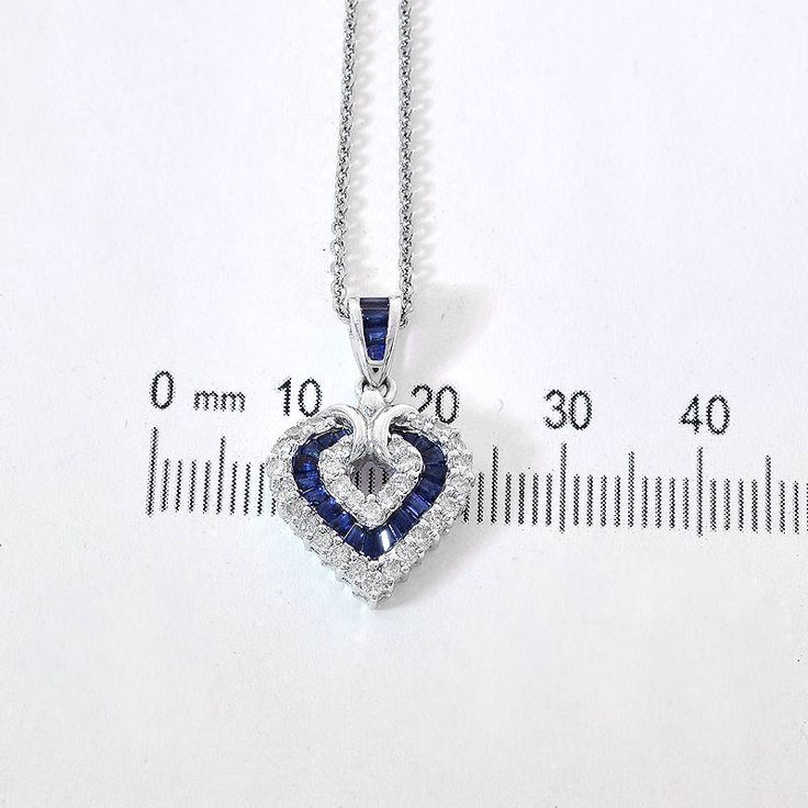 "This marvelous open heart shaped gemstone pendant necklace showcases baguette cut sapphires set in a channel setting & crafted in 14k white gold.The contemporary heart shaped pendant features bright round cut diamonds 0.50 c.t.w., color/clarity G,H-SI alternating with baguette cut sapphires 0.50 c.t.w. Enjoy a matching 14k white gold 18\" long chain with your purchase. Chain secures with lobster claw clasp. Necklace weight is 5.6 grams. For more information, contact Avital & Co Jewelry Heart Cut Sapphire Jewelry Gift, Heart Cut Sapphire Jewelry For Gifts, Heart Shaped Sapphire Jewelry Gift, Heart Shaped Sapphire Jewelry For Gifts, Heart-shaped Sapphire Jewelry Gift, Silver Sapphire Necklace With Heart Cut, Sapphire Heart Pendant Jewelry For Anniversary, Heart-shaped Sapphire Birthstone Jewelry, Heart-shaped Sapphire Necklace For Anniversary