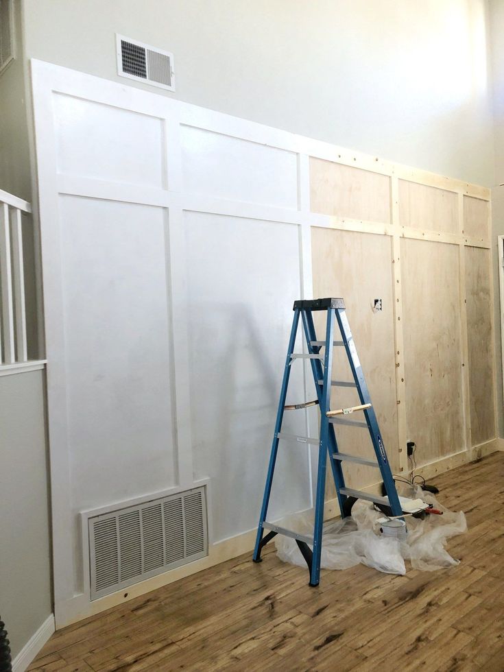 an empty room with white walls and wood flooring is being painted in the process of remodeling