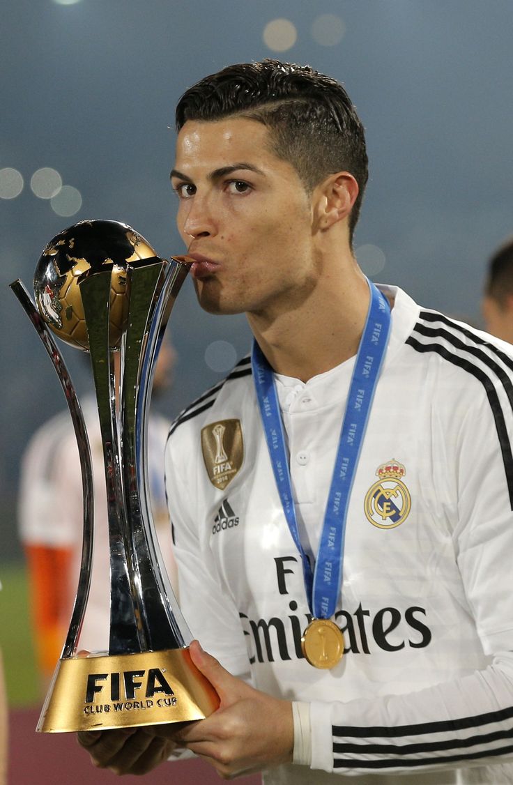 the soccer player is kissing the trophy