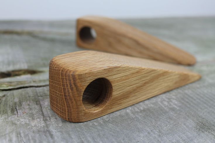 two wooden pegs sitting on top of a bed