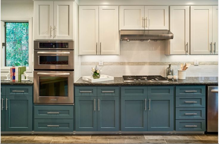 a kitchen with blue cabinets and stainless steel appliances, including an oven, microwave, dishwasher and stove