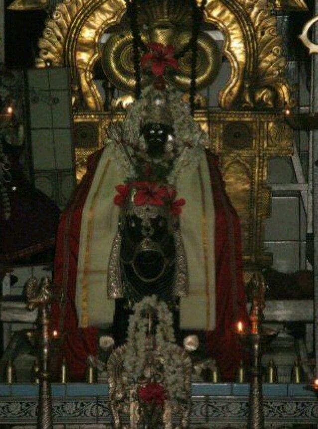 the statue is decorated with candles and decorations