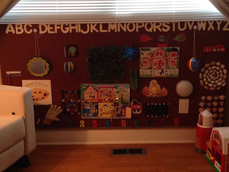 a child's playroom with lots of magnets on the wall