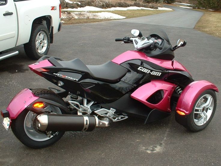 a pink and black motorcycle parked in a parking lot