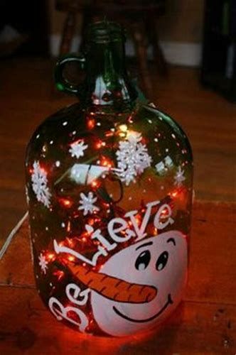 a glass bottle with christmas lights in the shape of a smiling snowman on it